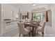 Bright dining room featuring a modern table set, large windows, and neutral decor at 11056 Kilkerran Ct, Las Vegas, NV 89141