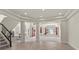 Bright foyer showcasing tile flooring, high ceilings, a staircase, and an open floor plan at 11056 Kilkerran Ct, Las Vegas, NV 89141