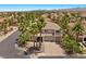 Beautiful two-story home with well-manicured landscaping, a circular driveway, and a three-car garage at 11056 Kilkerran Ct, Las Vegas, NV 89141