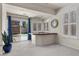 Bright game room with walk-behind bar and sliding glass doors to the backyard at 11056 Kilkerran Ct, Las Vegas, NV 89141
