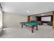 Spacious game room featuring a pool table, media screen, and plush carpeting for entertainment at 11056 Kilkerran Ct, Las Vegas, NV 89141