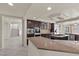 Modern kitchen featuring granite countertops, stainless steel appliances, and custom dark wood cabinetry at 11056 Kilkerran Ct, Las Vegas, NV 89141