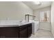 Well-lit laundry room equipped with sink, countertop, and modern washer and dryer at 11056 Kilkerran Ct, Las Vegas, NV 89141