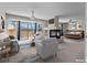 Open-concept living room with a fireplace, plenty of seating, and a view of the backyard at 11056 Kilkerran Ct, Las Vegas, NV 89141