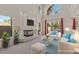 Bright living room with a fireplace, large windows, and sliding doors to the pool area at 11056 Kilkerran Ct, Las Vegas, NV 89141