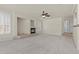 Expansive open living room featuring a fireplace and neutral carpet at 11056 Kilkerran Ct, Las Vegas, NV 89141