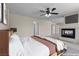 Staged bedroom with a fireplace, ceiling fan, and ample space for relaxing and sleeping at 11056 Kilkerran Ct, Las Vegas, NV 89141