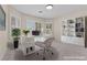 Bright home office with plantation shutters, a white desk, and a built-in bookshelf at 11056 Kilkerran Ct, Las Vegas, NV 89141