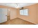 Bedroom with wood-look floors, ceiling fan with light, and window with blinds at 111 Narcissus Ln, Las Vegas, NV 89107