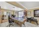 Spacious game room features a pool table, exercise equipment, and lots of natural light at 111 Narcissus Ln, Las Vegas, NV 89107