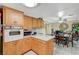 An open kitchen with wooden cabinets and views into the dining room at 111 Narcissus Ln, Las Vegas, NV 89107