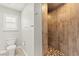 Modern bathroom showcasing a tiled walk-in shower and a window for natural light at 11274 Civita St, Las Vegas, NV 89141