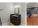 Bathroom featuring dark vanity, granite countertop, and entrance into the bedroom at 11274 Civita St, Las Vegas, NV 89141