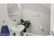 Elegant powder room featuring a pedestal sink, oval mirror, and modern fixtures at 11274 Civita St, Las Vegas, NV 89141