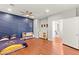 Bedroom featuring stylish decor, hardwood floors and view into hallway at 11274 Civita St, Las Vegas, NV 89141