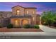Two-story home with a front yard featuring desert landscaping, a driveway, and a covered porch at 11274 Civita St, Las Vegas, NV 89141