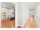 Hallway with hardwood floors leading to a bedroom featuring stylish decor and ample natural light at 11274 Civita St, Las Vegas, NV 89141