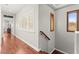 Upstairs hallway with hardwood floors, shuttered windows, and views of the house's interior at 11274 Civita St, Las Vegas, NV 89141