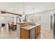 Modern kitchen with stainless steel appliances, granite countertops, and an island with pendant lighting at 11274 Civita St, Las Vegas, NV 89141