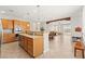 Spacious kitchen with an island that flows into the dining and living areas at 11274 Civita St, Las Vegas, NV 89141