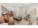 Bright living room with high ceilings, plantation shutters, and a wooden staircase at 11274 Civita St, Las Vegas, NV 89141