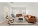 Living room with modern furniture, tile floors, plantation shutters and bright sunlight at 11274 Civita St, Las Vegas, NV 89141