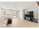 Bright living area with a ceiling fan and sliding doors to the backyard at 11274 Civita St, Las Vegas, NV 89141