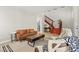 Bright living room features a cozy seating area and wooden stairs to the second floor at 11274 Civita St, Las Vegas, NV 89141