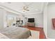 Bright main bedroom with a work space, large windows, and hardwood floors at 11274 Civita St, Las Vegas, NV 89141