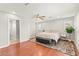 Spacious main bedroom with hardwood floors, a ceiling fan, and an ensuite bathroom at 11274 Civita St, Las Vegas, NV 89141