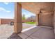 Covered patio with ceiling fan and brick-paved outdoor seating area, complemented by artificial grass at 11274 Civita St, Las Vegas, NV 89141