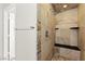 Updated shower stall featuring stone tile, built-in niche, and sleek showerhead at 11274 Civita St, Las Vegas, NV 89141