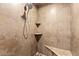 Tiled walk-in shower featuring corner shelves and a mosaic-tiled floor at 11274 Civita St, Las Vegas, NV 89141