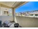 Inviting balcony featuring a comfortable seating area and serene views of the community at 11402 Ethereal Landing Ave, Las Vegas, NV 89138
