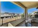 Spacious balcony features a cozy seating area and scenic views of the adjacent neighborhood at 11402 Ethereal Landing Ave, Las Vegas, NV 89138