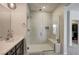 Bright bathroom featuring a glass shower with a built-in seat and a modern vanity at 11402 Ethereal Landing Ave, Las Vegas, NV 89138