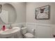 Stylish powder room boasts modern fixtures, framed mirror, and fresh decor at 11402 Ethereal Landing Ave, Las Vegas, NV 89138
