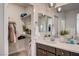 Stylish bathroom featuring a dark vanity, bright lighting, and a walk-in closet at 11402 Ethereal Landing Ave, Las Vegas, NV 89138