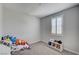Cozy bedroom with neutral walls, a window with shutters, and space for toys at 11402 Ethereal Landing Ave, Las Vegas, NV 89138