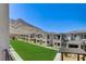 Beautiful townhome community nestled against a mountain with lush green common areas at 11402 Ethereal Landing Ave, Las Vegas, NV 89138