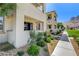 Charming townhome exterior with covered porch and views of lush community greenspace at 11402 Ethereal Landing Ave, Las Vegas, NV 89138