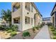 Modern townhome exterior with a private balcony and beautifully landscaped grounds at 11402 Ethereal Landing Ave, Las Vegas, NV 89138