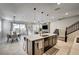 Bright open-concept kitchen featuring a center island with seating and seamless transition to dining area at 11402 Ethereal Landing Ave, Las Vegas, NV 89138