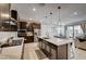 Gourmet kitchen with stainless steel appliances, island with sink, and modern pendant lighting at 11402 Ethereal Landing Ave, Las Vegas, NV 89138