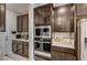 Well lit kitchen with stainless steel appliances, microwave and oven combo and dark wood cabinetry at 11402 Ethereal Landing Ave, Las Vegas, NV 89138