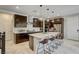 Modern kitchen featuring dark cabinetry, a waterfall island, and stainless steel appliances at 11402 Ethereal Landing Ave, Las Vegas, NV 89138
