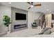 Living room showcases a modern fireplace, sleek design, and access to upper level staircase at 11402 Ethereal Landing Ave, Las Vegas, NV 89138