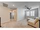 Spacious living room with a comfortable sectional sofa, ceiling fan and lots of light at 11402 Ethereal Landing Ave, Las Vegas, NV 89138