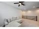 Spacious living room with a comfortable sectional sofa, ceiling fan and lots of light at 11402 Ethereal Landing Ave, Las Vegas, NV 89138