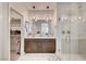 A luxurious main bathroom with double sinks, a walk-in shower, and access to a walk-in closet at 11402 Ethereal Landing Ave, Las Vegas, NV 89138